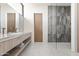 Modern bathroom with a double sink vanity, glass enclosed shower, and contemporary fixtures at 10641 E Blue Sky Dr, Scottsdale, AZ 85262