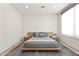 Minimalist bedroom features a wooden platform bed with gray linens, set on a modern gray rug atop wood floors at 10641 E Blue Sky Dr, Scottsdale, AZ 85262