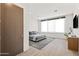 Bright bedroom features sleek wood floors, a minimalist platform bed, and modern decor for a serene, stylish space at 10641 E Blue Sky Dr, Scottsdale, AZ 85262