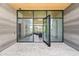 Grand entryway with marble floors, wood ceilings, black framed glass doors and views to living area at 10641 E Blue Sky Dr, Scottsdale, AZ 85262