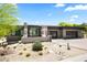 Contemporary home with a desert landscape, grey exterior, two-car garage, and modern architecture at 10641 E Blue Sky Dr, Scottsdale, AZ 85262