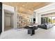Stylish living room features tile flooring, wood ceilings, glass-enclosed wine room and modern decor at 10641 E Blue Sky Dr, Scottsdale, AZ 85262
