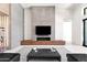 Sophisticated living room boasts a modern fireplace, sleek seating and built-in wine storage at 10641 E Blue Sky Dr, Scottsdale, AZ 85262
