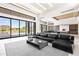 Bright, open-concept living room with large windows, tile floors, and views to the dining and kitchen area at 10641 E Blue Sky Dr, Scottsdale, AZ 85262