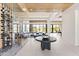 Open living space with a glass-enclosed wine room, tile floors, wood ceilings and mountain views at 10641 E Blue Sky Dr, Scottsdale, AZ 85262