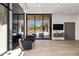 Open bedroom with view to pool, with built in entertainment center, fireplace, and hard wood floors at 10641 E Blue Sky Dr, Scottsdale, AZ 85262