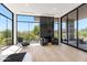 Relaxing main bedroom featuring a large window with beautiful outdoor views, fireplace, and contemporary furnishings at 10641 E Blue Sky Dr, Scottsdale, AZ 85262