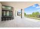 Outdoor bar area with a bar, stools, a water feature, desert views, and access to the pool and patio at 10641 E Blue Sky Dr, Scottsdale, AZ 85262