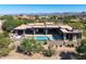 Modern home featuring a sleek pool, covered patio and desert landscaping at 10641 E Blue Sky Dr, Scottsdale, AZ 85262