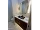 Sleek powder room showcasing modern fixtures, marble countertop, and unique lighting at 10821 E Troon North Dr, Scottsdale, AZ 85262