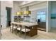 Bright kitchen featuring an island with seating, stainless appliances, and modern lighting at 10821 E Troon North Dr, Scottsdale, AZ 85262