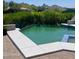 Inviting swimming pool surrounded by lush greenery and beautiful mountain views at 10821 E Troon North Dr, Scottsdale, AZ 85262