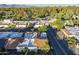 An aerial view of a community with lush green landscaping, tile roofs, with mountain views in the background at 11416 N Century Ln, Scottsdale, AZ 85254