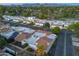 Overhead shot of a community displaying well-kept residences, solar panels, verdant landscapes, and mountainous backdrops at 11416 N Century Ln, Scottsdale, AZ 85254