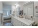 Bathroom features a double vanity, marble countertop, decorative tile flooring, and shower at 11416 N Century Ln, Scottsdale, AZ 85254