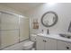 Cozy bathroom featuring a decorative mirror, shower with frosted glass, and white vanity at 11416 N Century Ln, Scottsdale, AZ 85254