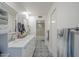 Bathroom featuring a double vanity, marble countertop, and shower with decorative tile flooring at 11416 N Century Ln, Scottsdale, AZ 85254
