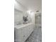 Bathroom featuring a double vanity, marble countertop, and shower with decorative tile flooring at 11416 N Century Ln, Scottsdale, AZ 85254
