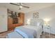 Bedroom with neutral decor, ceiling fan, storage cabinet and exercise bike setup at 11416 N Century Ln, Scottsdale, AZ 85254