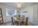 Bright dining area with a round wooden table and large window providing natural light at 11416 N Century Ln, Scottsdale, AZ 85254