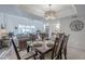 Dining room with a table set for six, open to living room and kitchen at 11416 N Century Ln, Scottsdale, AZ 85254