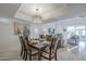 Dining room with a contemporary light fixture, neutral walls, and seating for eight at 11416 N Century Ln, Scottsdale, AZ 85254