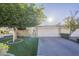 Well-maintained single-story home featuring artificial turf, mature trees, and a two-car garage at 11416 N Century Ln, Scottsdale, AZ 85254