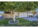 House featuring a private gated entry, two car garage and well-maintained lawn with mature landscaping at 11416 N Century Ln, Scottsdale, AZ 85254