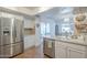 Spacious kitchen features stainless steel refrigerator, and convenient access to an outdoor patio at 11416 N Century Ln, Scottsdale, AZ 85254