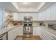 A well-lit kitchen with white cabinetry, stainless steel appliances, and patterned backsplash at 11416 N Century Ln, Scottsdale, AZ 85254