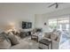 Comfortable living room with two sofas, a fireplace, sliding glass doors and a ceiling fan at 11416 N Century Ln, Scottsdale, AZ 85254