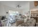 Bright living room with tile floors, comfortable seating and sliding glass doors to backyard at 11416 N Century Ln, Scottsdale, AZ 85254