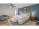 Stylish main bedroom featuring a plush bed, accent wall, and ceiling fan for added comfort at 11416 N Century Ln, Scottsdale, AZ 85254
