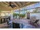 Covered patio featuring an outdoor grilling station, ceiling fan, and decorative wall at 11416 N Century Ln, Scottsdale, AZ 85254