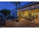 Inviting covered patio features comfortable seating, seamless access through sliding glass doors, and ambient string lights at 11416 N Century Ln, Scottsdale, AZ 85254