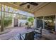Covered patio with grill station, cozy seating, and beautiful garden and fence at 11416 N Century Ln, Scottsdale, AZ 85254