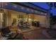 Relaxing covered patio featuring stylish seating, an outdoor bar, and ambient lighting, creating an inviting outdoor space at 11416 N Century Ln, Scottsdale, AZ 85254