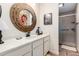 Bathroom with stylish vanity, mirror, and walk-in shower at 13889 N 108Th Dr, Sun City, AZ 85351
