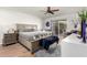 Comfortable bedroom featuring stylish furnishings, a ceiling fan, and a sliding glass door to the outside at 13889 N 108Th Dr, Sun City, AZ 85351