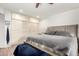 Neutral color palette bedroom with closet space, wood floors, and bench at 13889 N 108Th Dr, Sun City, AZ 85351