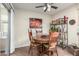 Cozy dining area features a round table, chairs, and shelving with decor at 13889 N 108Th Dr, Sun City, AZ 85351