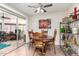 Cozy dining area features a round table, chairs, and shelving with decor and sliding glass doors at 13889 N 108Th Dr, Sun City, AZ 85351
