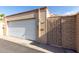 Exterior garage view showing the door, the gate with floral accents and house numbers at 13889 N 108Th Dr, Sun City, AZ 85351