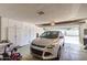 Garage interior shows a parked silver SUV and ample built-in storage cabinets at 13889 N 108Th Dr, Sun City, AZ 85351