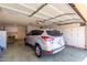 Spacious garage with ample built-in storage cabinets and a parked silver SUV at 13889 N 108Th Dr, Sun City, AZ 85351