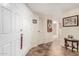 Hallway featuring ceramic tile flooring, white paneled doors, and decorative artwork at 13889 N 108Th Dr, Sun City, AZ 85351