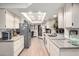 Spacious kitchen featuring modern appliances, ample countertop space, and a bright skylight at 13889 N 108Th Dr, Sun City, AZ 85351