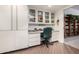Bright office featuring built-in shelves and drawers and glass-door display cabinets at 13889 N 108Th Dr, Sun City, AZ 85351