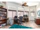 Bright office space with ample natural light, built-in shelving, and functional work area at 13889 N 108Th Dr, Sun City, AZ 85351