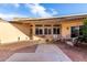 Covered patio shows seating, brick pavers, and mature landscape details at 13889 N 108Th Dr, Sun City, AZ 85351